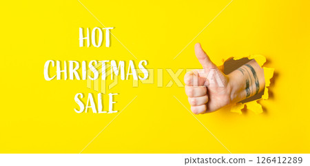 A hand giving a thumbs up with the words Hot Christmas Sale 126412289