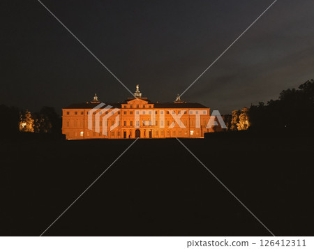A large building with a lot of windows is lit up at night A large building with a lot of windows is lit up at night 126412311