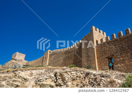 Albarracin fortress wall with hikers 126412567