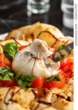 Portion of italian style focaccia with buratta Portion of italian style focaccia with buratta 126412707