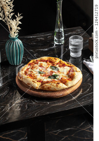 Portion of baked italian pizza margherita 126412719