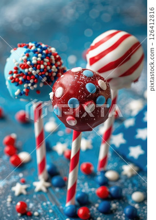 July 4th baking idea, USA Independence Day, berry American flag cake pops decorated with icing, blue background, vertical banner 126412816
