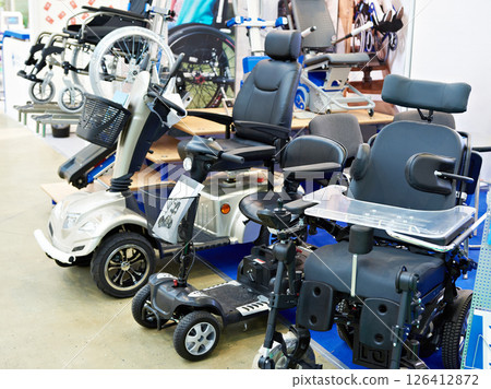 Wheelchairs with electric motor in store Wheelchairs with electric motor in store 126412872