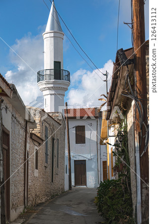 White minaret towering over narrow street in Pano Lefkara, Cyprus White minaret towering over narrow street in Pano Lefkara, Cyprus 126413112