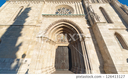 Matthias church facade with ornate carvings and iron doors in budapest hungary 126413127