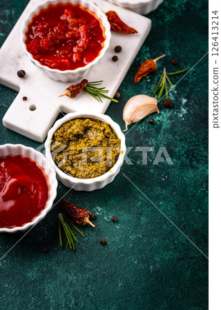 Set of different sauces. Ketchup, mustard, pesto 126413214