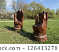 Two Wooden Armchairs Sculpted as Giant Hands in Park 126413278