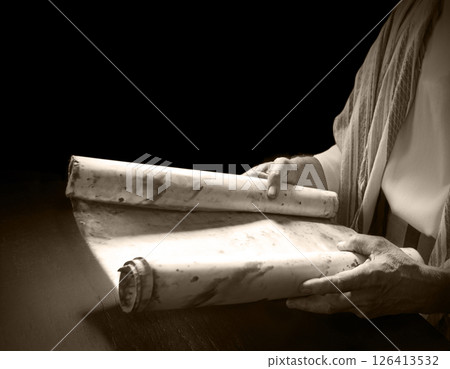 Man's hans holding a scroll 126413532