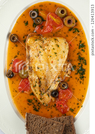 Portion of dorado fish with puttanesca sauce Portion of dorado fish with puttanesca sauce 126413913