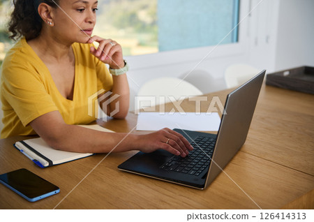 Woman Working Remotely at Home Office in a Relaxed Setting 126414313