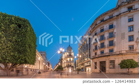 Illuminated Adriatica building on Avenida de la Constitucion at night, Seville, Spain 126414983