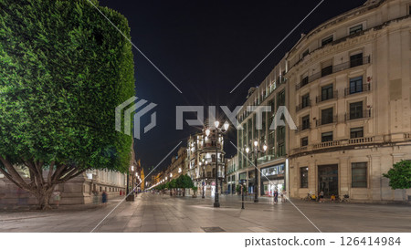 Illuminated Adriatica building on Avenida de la Constitucion at night, Seville, Spain 126414984