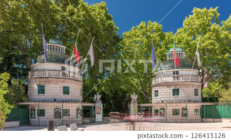 Timelapse hyperlapse of Lisbon Zoo entrance with open gates and flags on towers during summer. Lisbon, Portugal Timelapse hyperlapse of Lisbon Zoo entrance with open gates and flags on towers during summer. Lisbon, Portugal 126415126