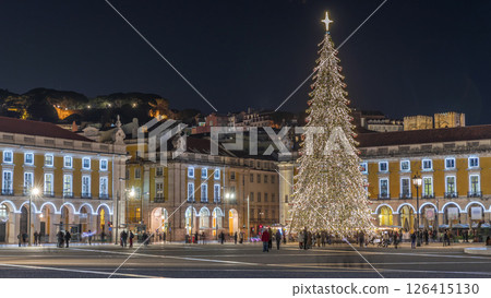 Commerce Square in Lisbon illuminated at Christmas hyperlapse, with a towering tree and crowds celebrating at night. Portugal 126415130
