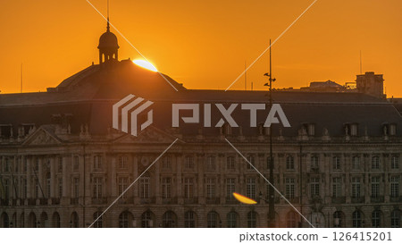 Sunset view of Bordeaux city skyline featuring spires and rooftops on a waterfront. Sunset view of Bordeaux city skyline featuring spires and rooftops on a waterfront. 126415201