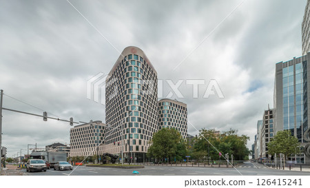 Timelapse panorama of traffic and modern office buildings in the business district on Boulevard Baudouin, Brussels, Belgium. Timelapse panorama of traffic and modern office buildings in the business district on Boulevard Baudouin, Brussels, Belgium. 126415241