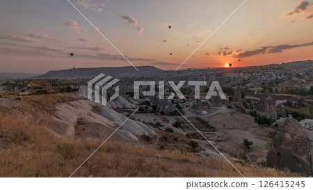 Beautiful sunrise with colorful hot air balloons take off and flying in clear morning sky aerial timelapse in Cappadocia, Turkey 126415245