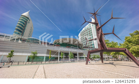 Visitors coming in and out of the Vasco da Gama Shopping mall timelapse hyperlapse, modern towers in the background. Lisbon, Portugal Visitors coming in and out of the Vasco da Gama Shopping mall timelapse hyperlapse, modern towers in the background. Lisbon, Portugal 126415295
