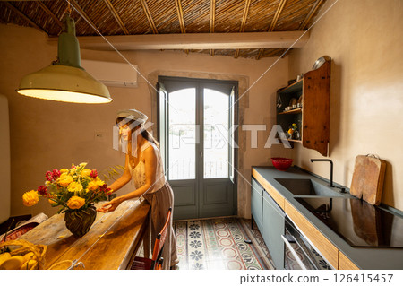 Cozy Sicilian kitchen with flowers and sunlight Cozy Sicilian kitchen with flowers and sunlight 126415457