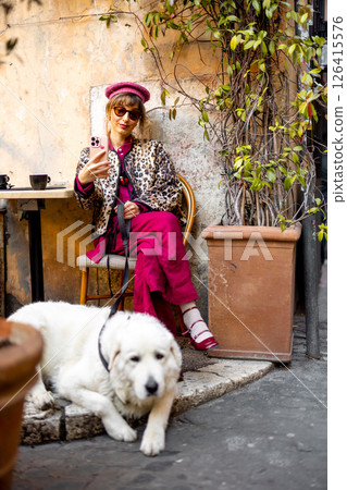 Woman with dog at rustic Roman cafe 126415576