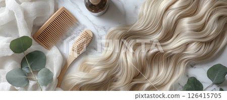 Blonde hair extensions with wooden comb and brush on marble background 126415705