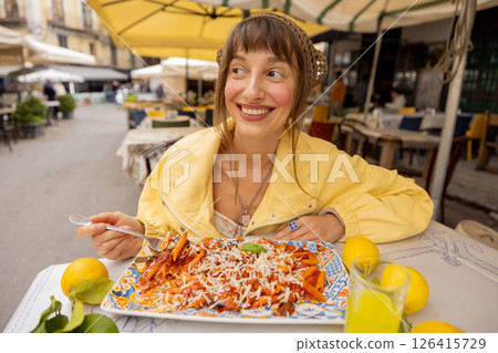 Happy woman enjoying Sicilian pasta 126415729