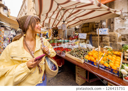 Choosing greens at Sicilian street market 126415731