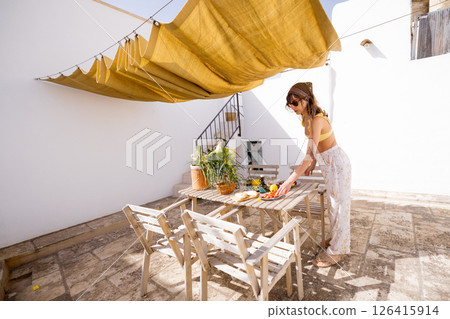 Rustic rooftop brunch under sunshade Rustic rooftop brunch under sunshade 126415914