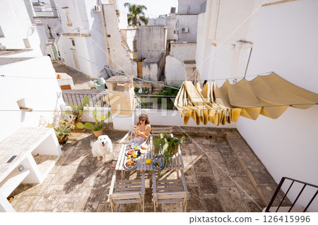 Sunny Mediterranean breakfast on rustic rooftop 126415996