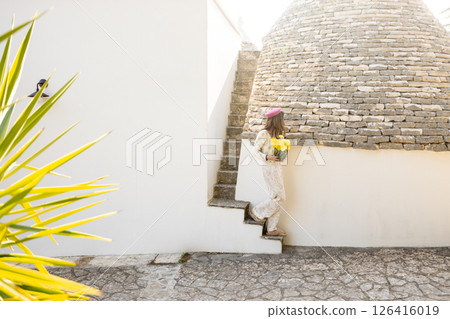 Yellow flowers and stone roof 126416019