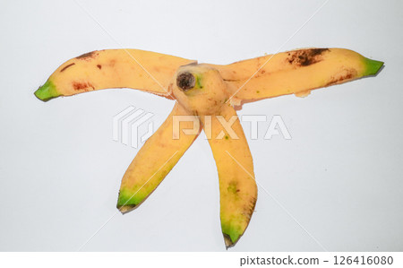 Yellow banana peel on white background  126416080