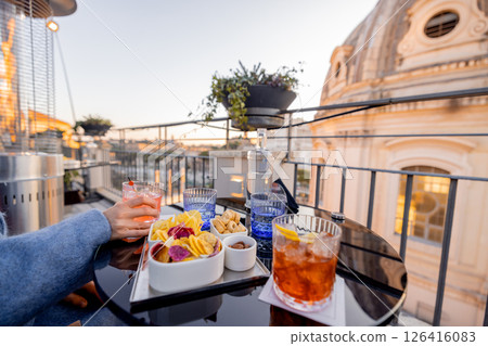 Aperitivo with a Roman rooftop view Aperitivo with a Roman rooftop view 126416083