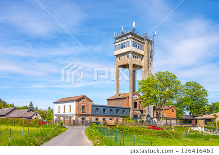 Rudolfka lookout tower stands prominently in Bohutin, Czechia, showcasing its former mining heritage. Visitors can admire the unique architecture under a clear blue sky. 126416461