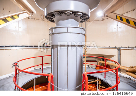 Inside the Orlik Hydroelectric Power Station in Czechia, a large Kaplan turbine is prominently displayed. The structure showcases the engineering behind hydroelectric power generation. 126416649