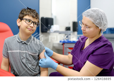 A boy is being vaccinated. A child is given a vaccine during an epidemic or outbreak of a disease. A boy is being vaccinated. A child is given a vaccine during an epidemic or outbreak of a disease. 126416695