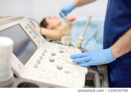 Mammologist doctor examines a woman breasts and lymph nodes using ultrasound. Mammography and ultrasound scanning are main methods of instrumental diagnosis of mammary glands. Breast cancer 126416700