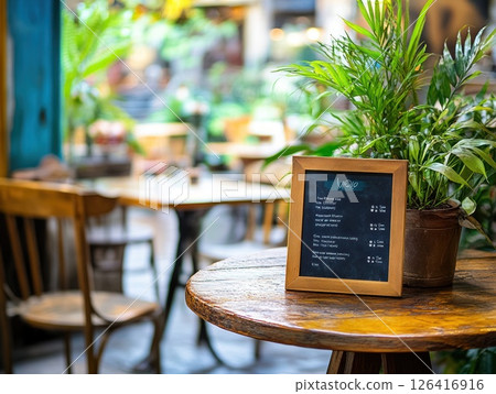 Wooden table with menu in cozy cafe with plants Wooden table with menu in cozy cafe with plants 126416916