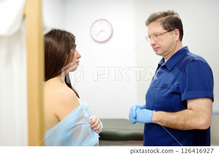 Doctor mammologist examines woman breasts and lymph nodes. Correcting the shape of the breast - lift, reduction, reconstruction, augmentation. Problems of lactation. Breast cancer. Doctor mammologist examines woman breasts and lymph nodes. Correcting the shape of the breast - lift, reduction, reconstruction, augmentation. Problems of lactation. Breast cancer. 126416927
