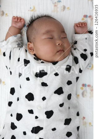 A 3-month-old baby girl sleeping in a "banzai" pose A 3-month-old baby girl sleeping in a "banzai" pose 126416935