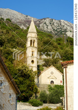Picturesque view of Church Our Lady of the Rosary with mountains in the background. Tourist sights in Perast, Montenegro 126417040