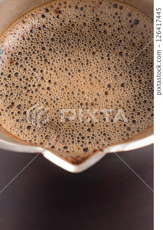 Coffee prepared in a Turk macro photo as a background. 126417445