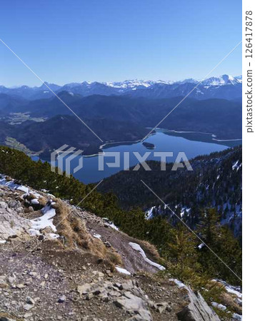 Breathtaking view of a serene mountain lake surrounded by majestic peaks during a clear, sunny day Breathtaking view of a serene mountain lake surrounded by majestic peaks during a clear, sunny day 126417878