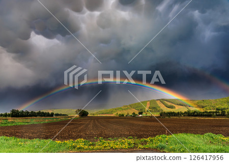 A miraculous arch over farmland after the rain A miraculous arch over farmland after the rain 126417956