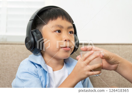 Back to School: Boy Receiving Drink from Caregiver Back to School: Boy Receiving Drink from Caregiver 126418365