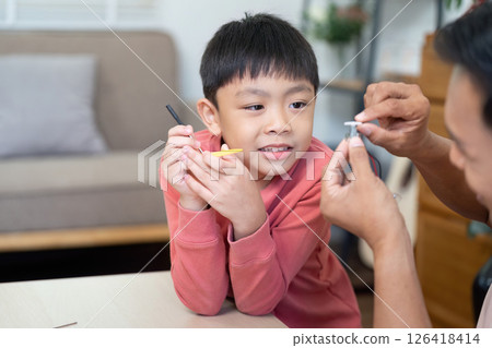 Activity of father and son having fun with DIY learning tools 126418414
