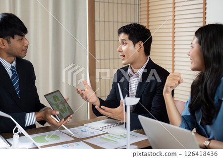 Sustainability and ESG. Engaged team discussing eco-friendly business strategies in a modern office. 126418436