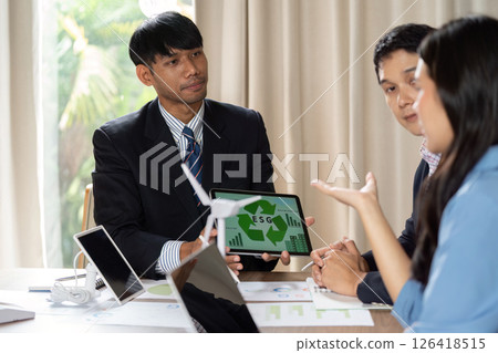 ESG Presentation. Team discussing environmental, social, and governance strategies in a collaborative setting. 126418515