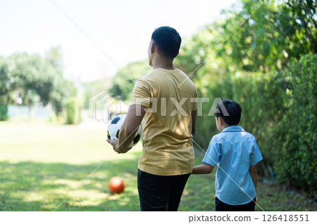 Activity: Father and Son Walking Together After Playing Soccer 126418551