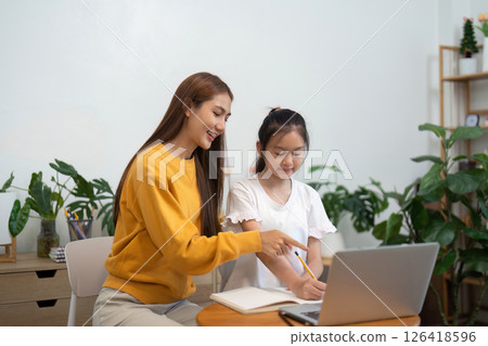 Back to school guidance with mother teaching daughter on a laptop Back to school guidance with mother teaching daughter on a laptop 126418596