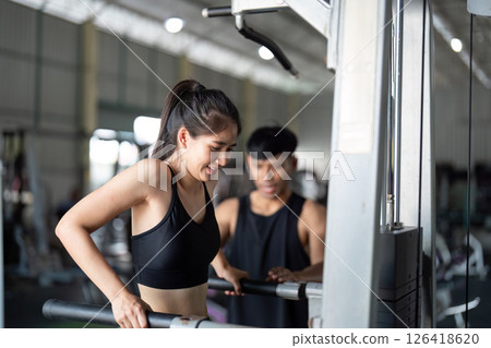 Wellness and Strength Training. Woman exercising with personal trainer in gym. 126418620